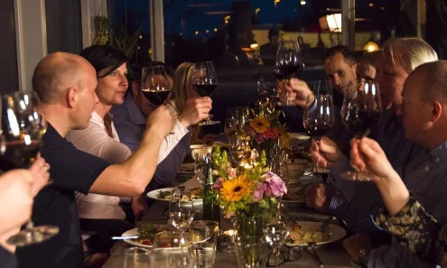 En gruppe som skåler med vinglass på restaurant